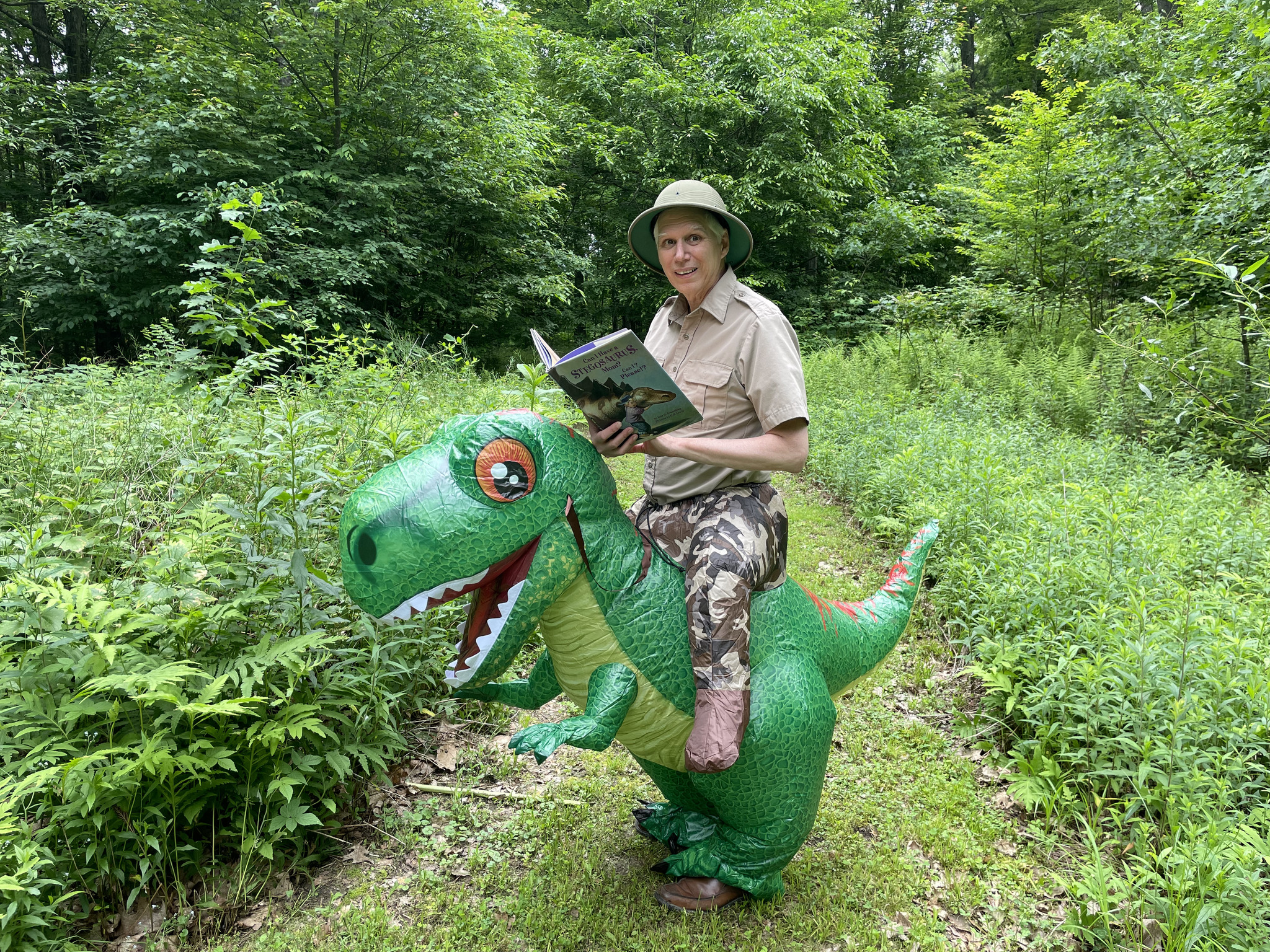 Safari Sam on dinosaur reading a book